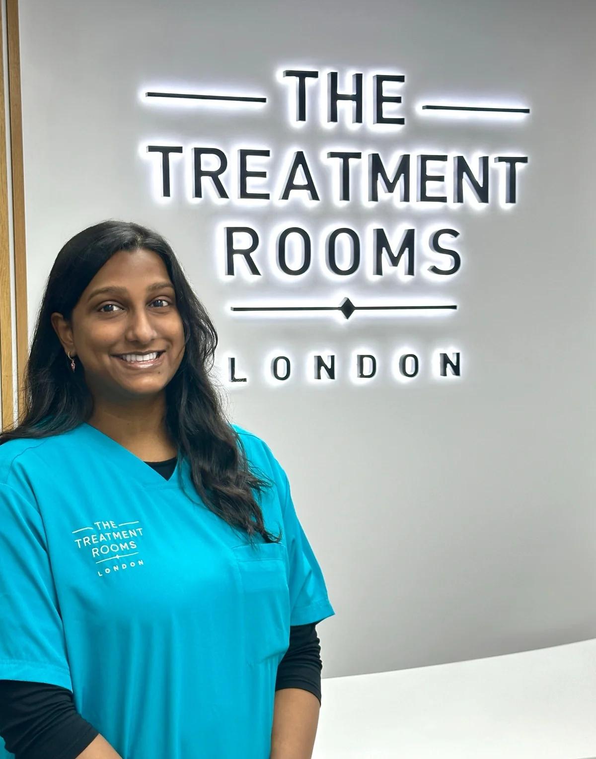 Puroshini stands outside her hair transplant clinic