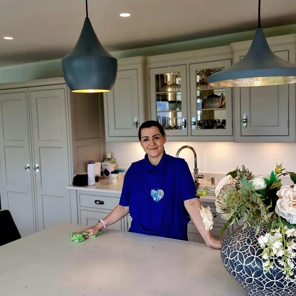 Kelly cleaning a client's kitchen