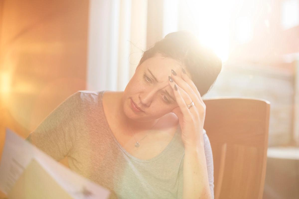 Worried looking woman reads a letter