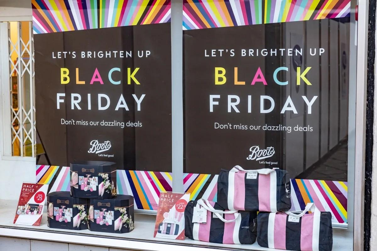 Black Friday shoppers comparing deals before spending