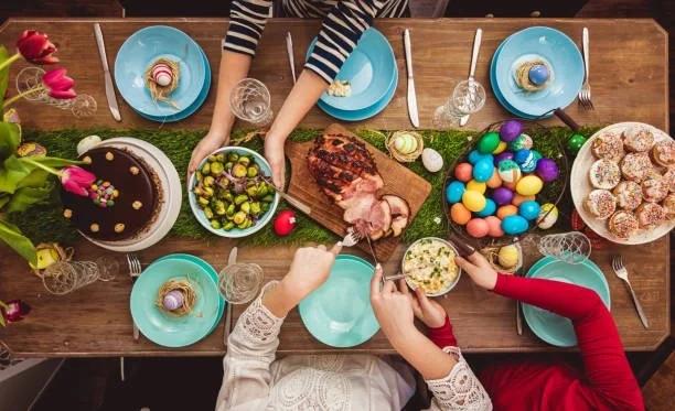 Image of people serving Easter lunch. How to bag 4p veg and super cheap lamb this Easter. Serve up Easter lunch for less this year. 2026
