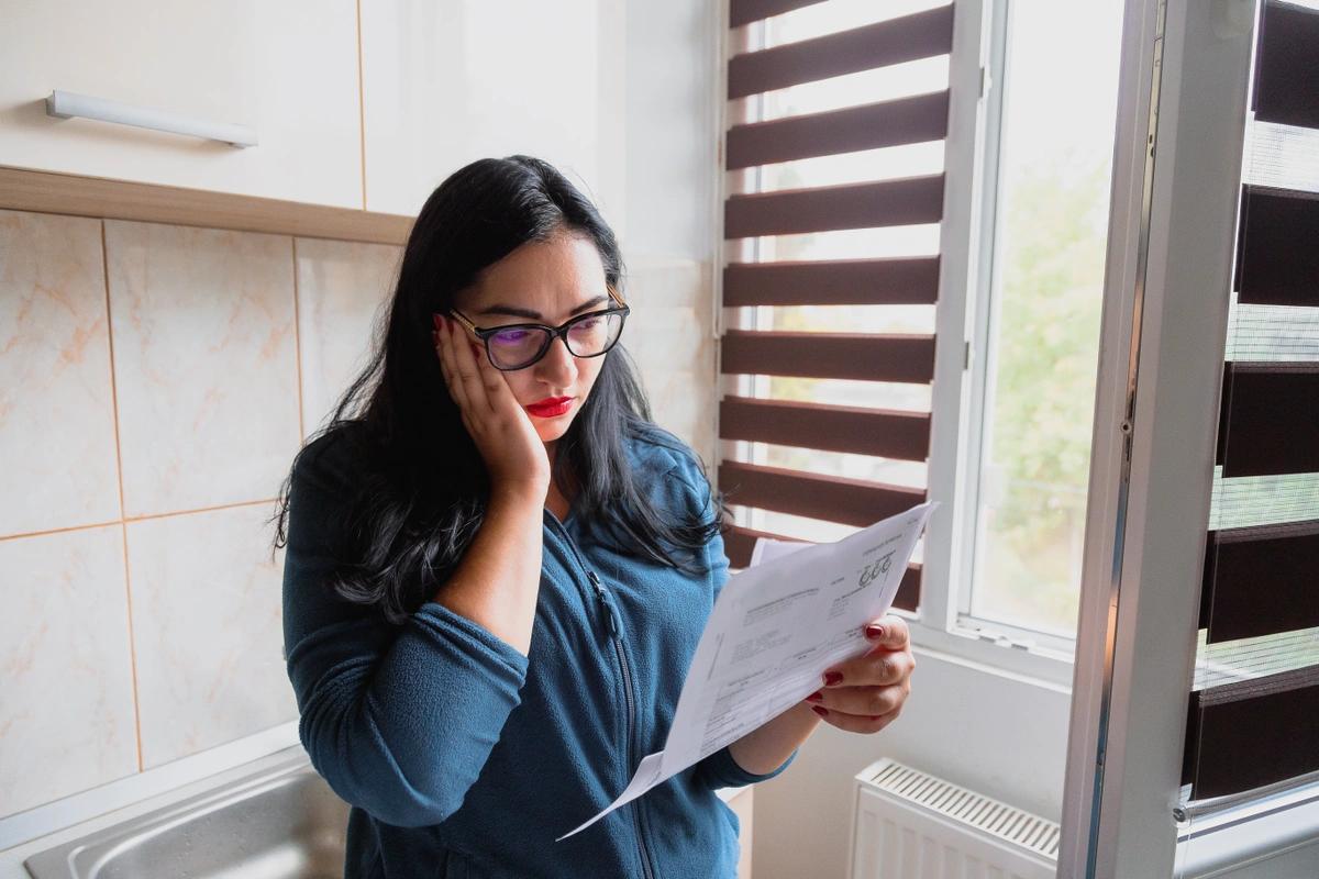 Worried looking woman reading an energy bill