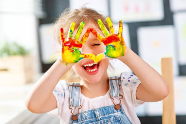 Young child with painted hands