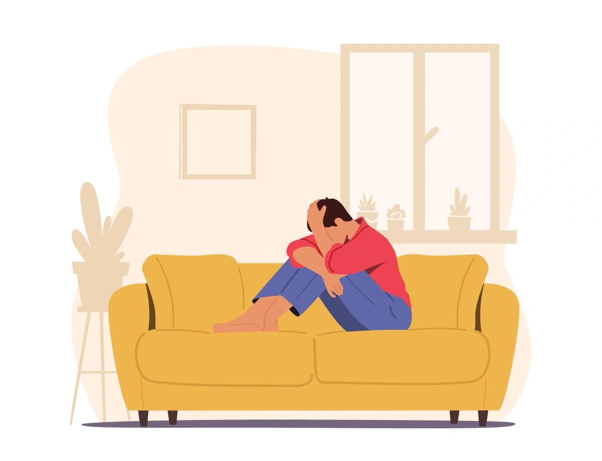 An illustration of a man sitting on the couch with his head in his hands.