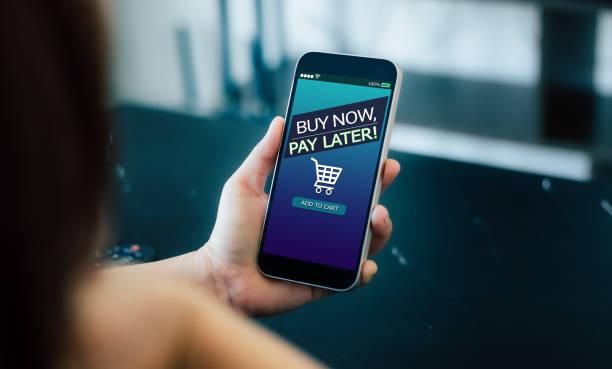 Image of a person holding a phone with a buy now pay later check out screen open