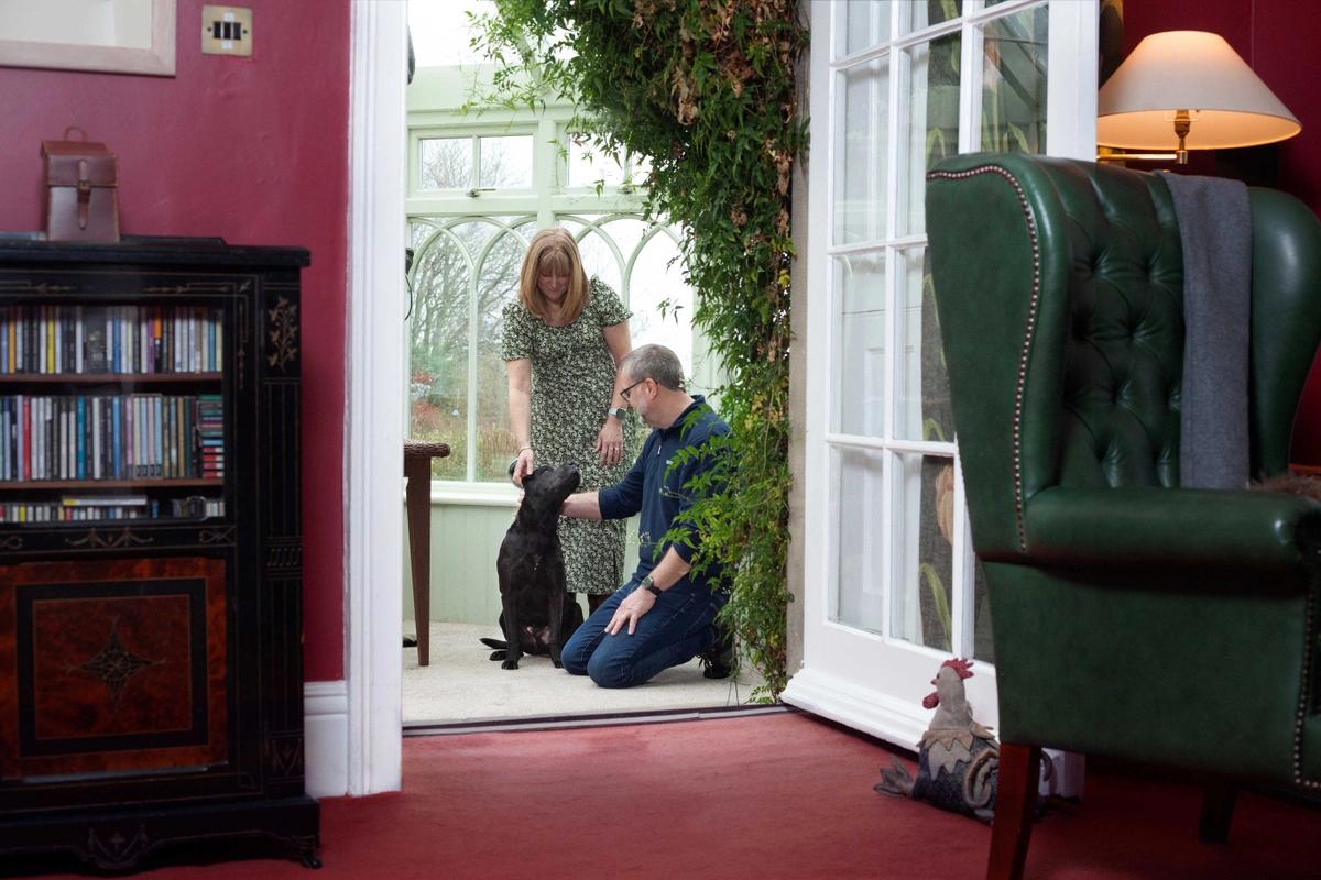 Frank and Donna playing with one of their client's dogs
