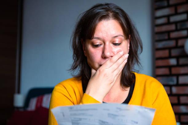 Image of someone looking worried about receiving debt collection notices. How to deal with creditors when you're struggling with debt
