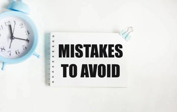 Image of a clock and a sign that says 'mistakes to avoid' The 3 money mistakes that will wreck your January. New Year money traps to avoid at all costs - and where to get help