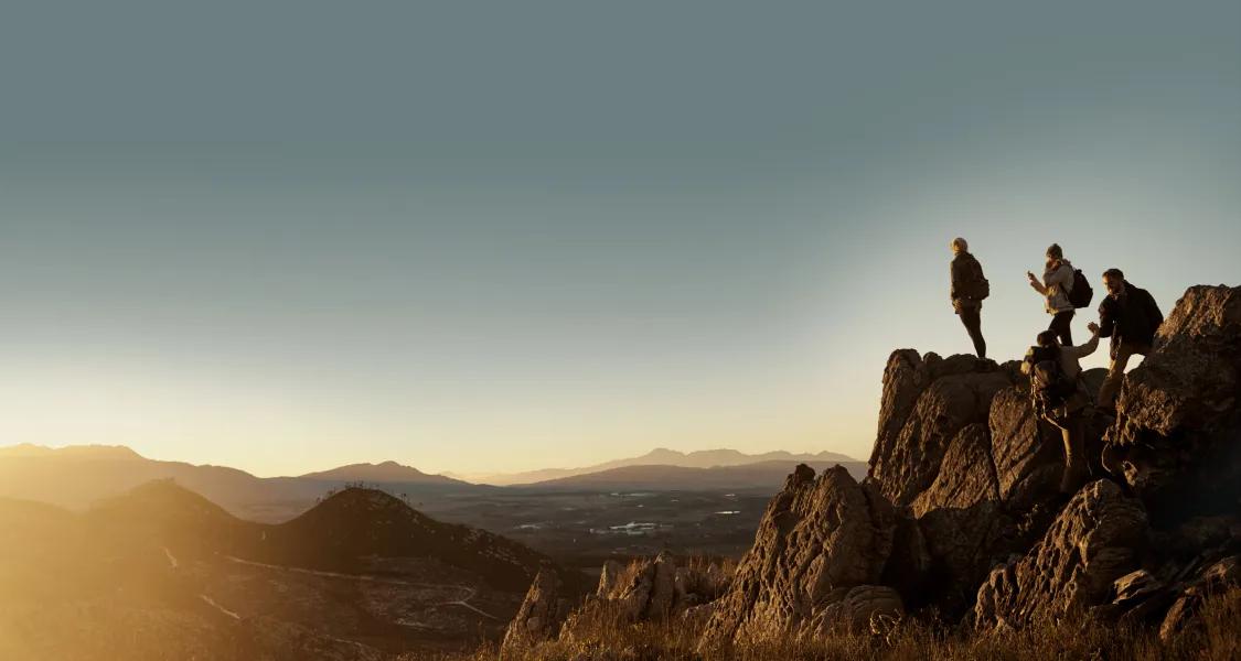 Group of climbers reaching the top of a mountain